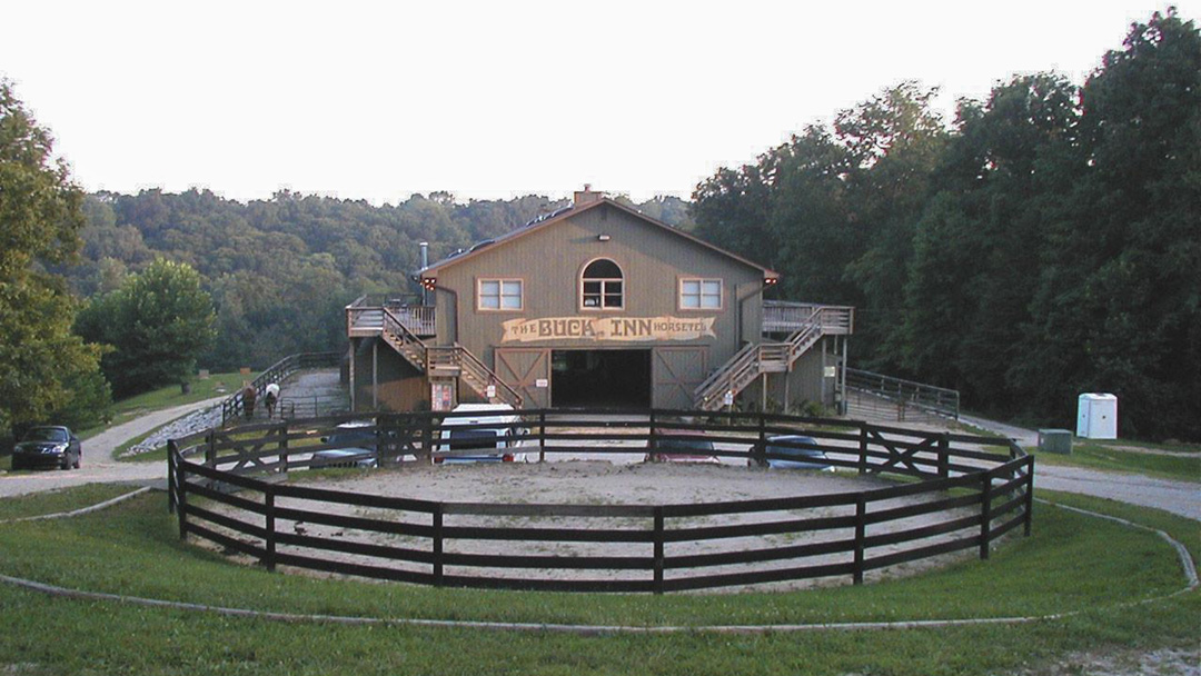 Aerial shot of Rawhide Ranch barn and corral surrounded by lush woods