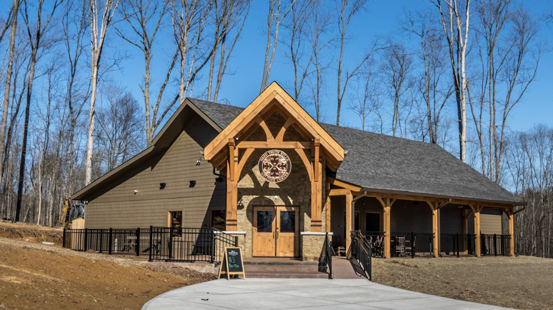 Exterior of Hard Truth Hills Distillery with bright blue sky