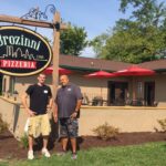 Brozinni's with Ryan Seward in front of sign