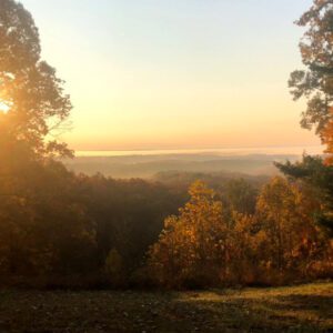 A scenic hilltop view at sunset.